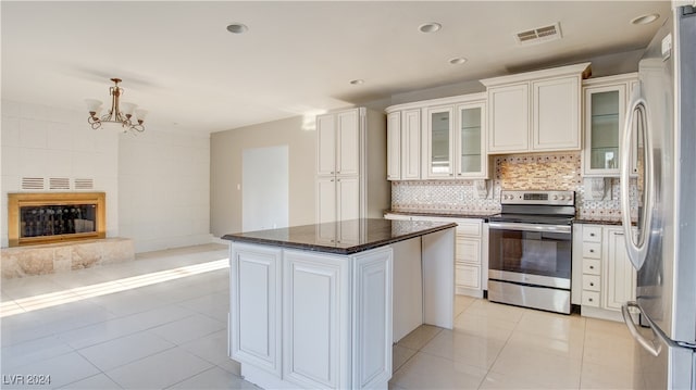 kitchen featuring a center island, appliances with stainless steel finishes, decorative backsplash, and white cabinets