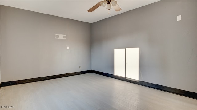 empty room featuring light wood-type flooring and ceiling fan