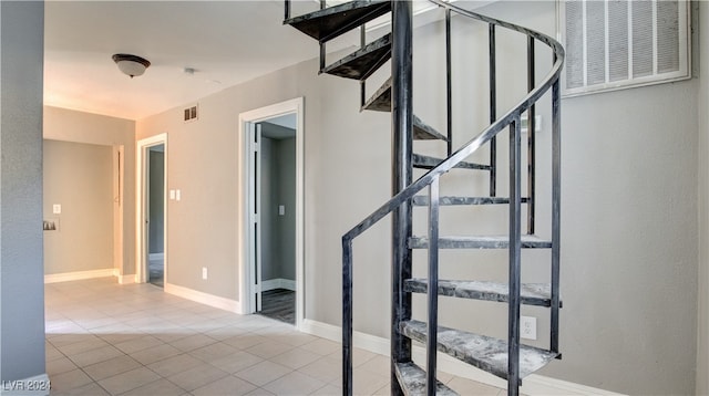 staircase featuring tile patterned flooring