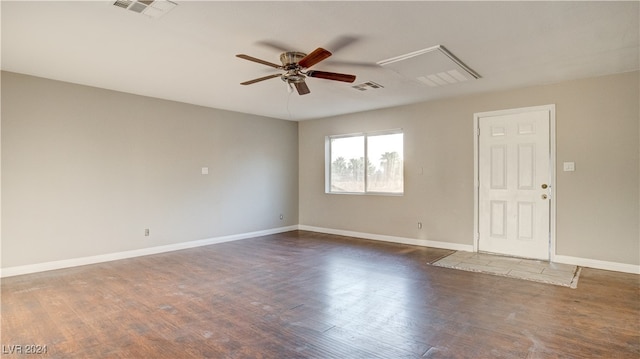 empty room featuring dark wood-type flooring and ceiling fan