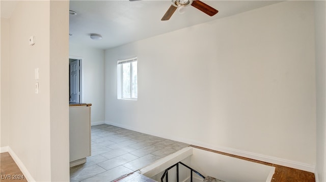 empty room featuring tile patterned flooring and ceiling fan