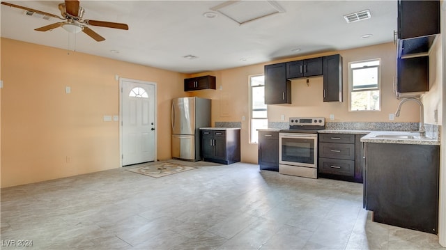 kitchen featuring dark brown cabinets, stainless steel appliances, and sink