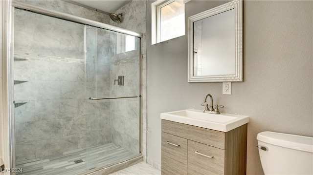 bathroom featuring vanity, toilet, and an enclosed shower