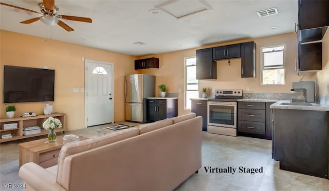 kitchen with light tile patterned floors, ceiling fan, sink, and appliances with stainless steel finishes