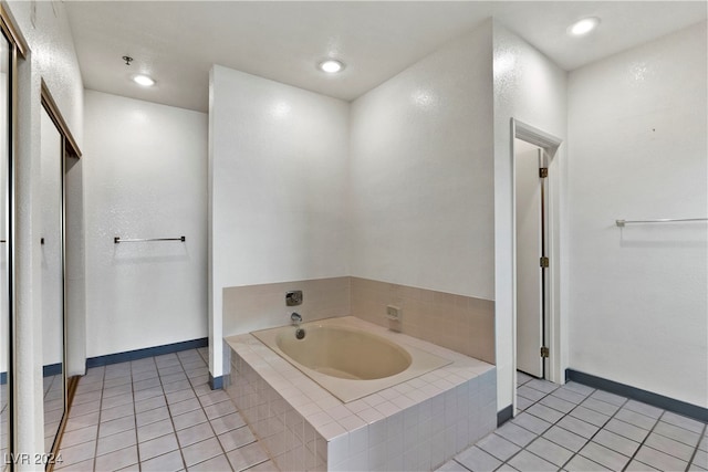 bathroom featuring tile patterned flooring and tiled bath