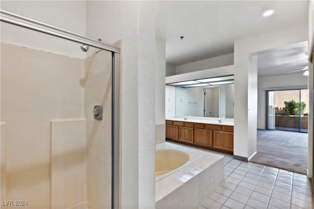 bathroom with shower with separate bathtub, vanity, and tile patterned floors