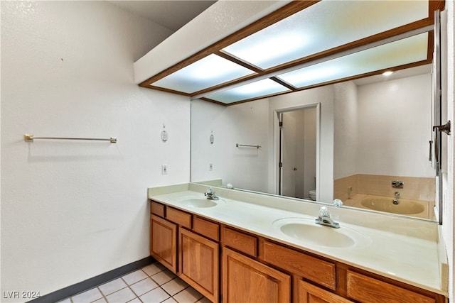 bathroom with tile patterned flooring, toilet, vanity, and a bathtub