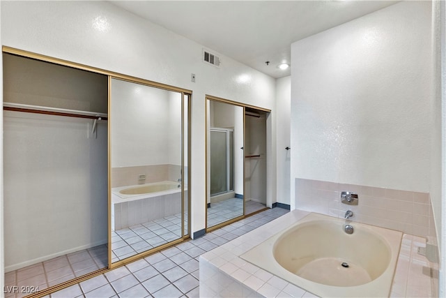 bathroom featuring plus walk in shower and tile patterned floors