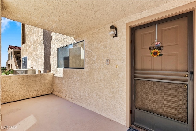 doorway to property featuring cooling unit