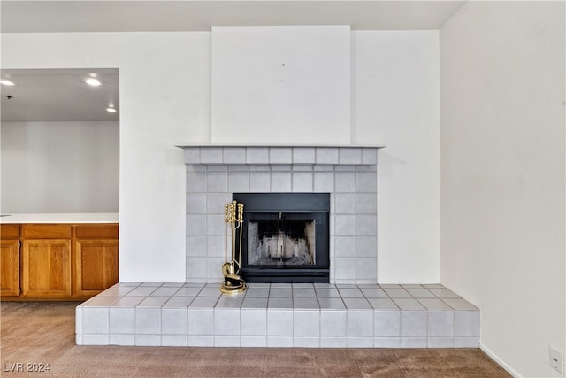 interior details featuring a fireplace and carpet