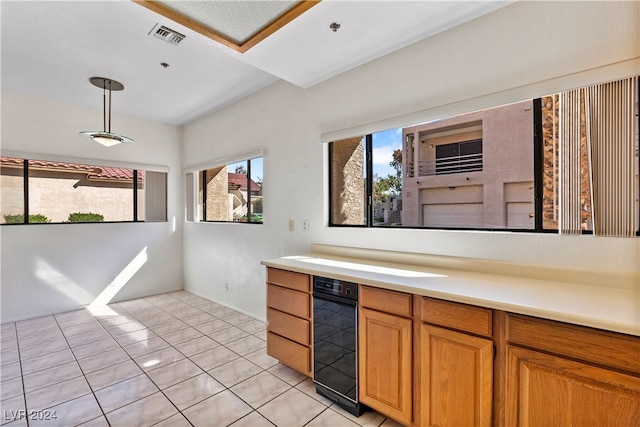 kitchen with light tile patterned floors and decorative light fixtures