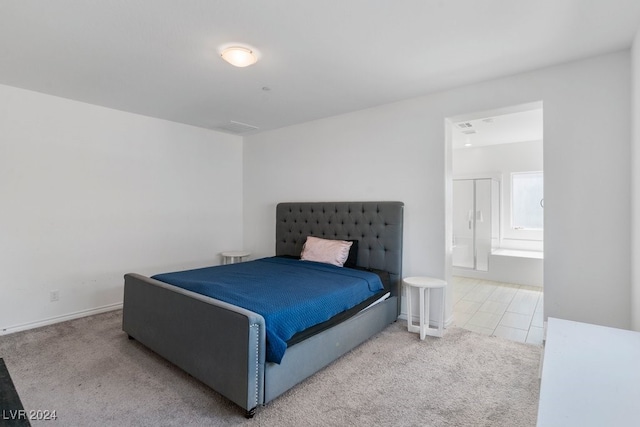 carpeted bedroom featuring ensuite bath