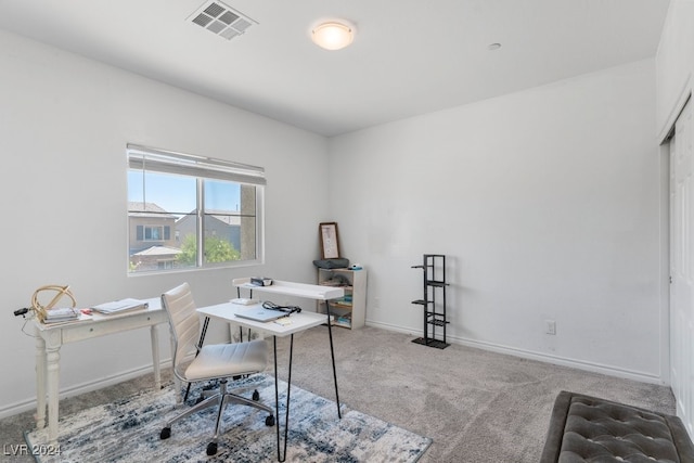 carpeted office space featuring visible vents and baseboards