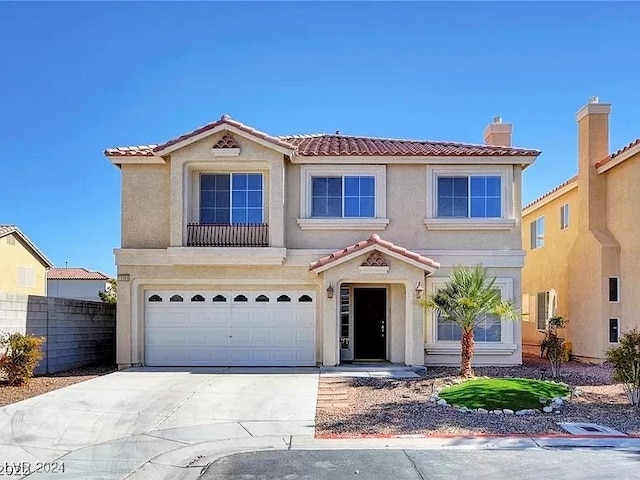 mediterranean / spanish house with a garage