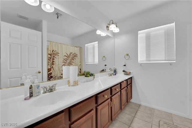 full bath with tile patterned flooring, visible vents, double vanity, and a sink