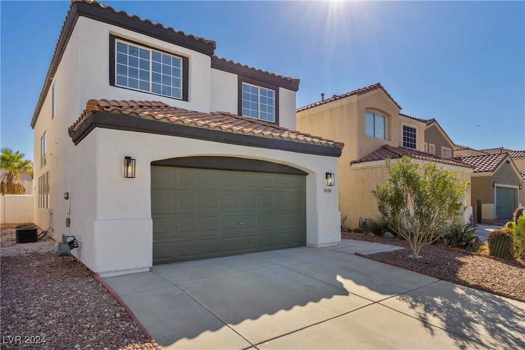 mediterranean / spanish house featuring a garage