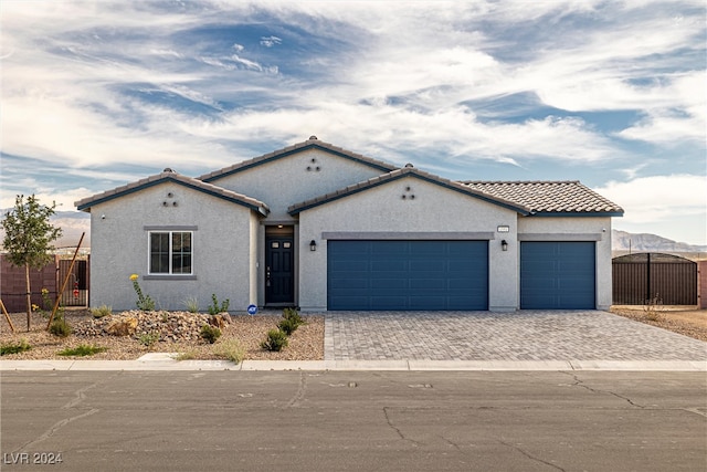 view of front of home featuring a mountain view and a garage