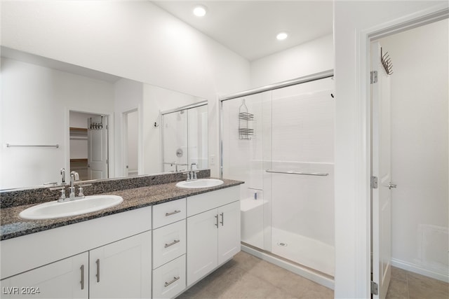 bathroom featuring vanity and a shower with shower door