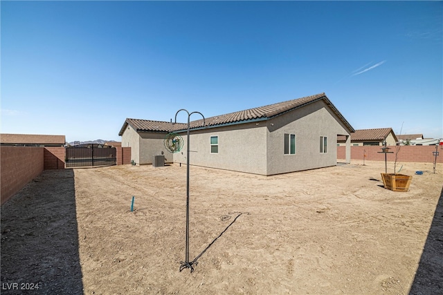 rear view of property featuring central AC unit