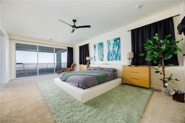 bedroom with ceiling fan, carpet floors, and access to outside