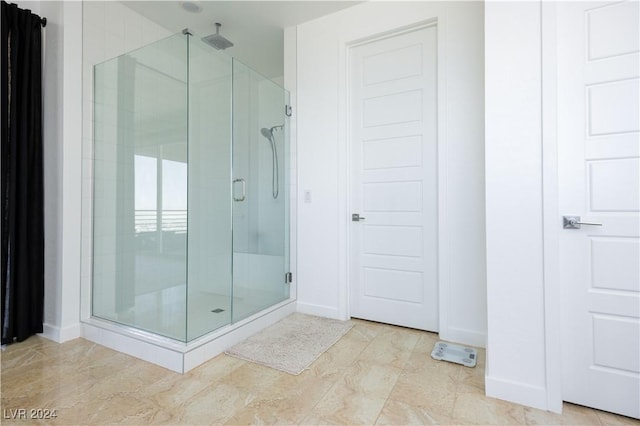 bathroom with a shower with shower door and tile patterned flooring