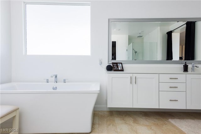 bathroom featuring independent shower and bath and vanity