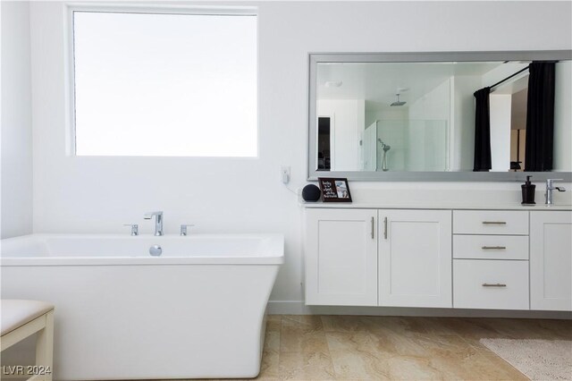 510 Duvet Ct, Henderson, NV 89012 - full bath featuring vanity, a wealth of natural light, a shower, and a freestanding bath
