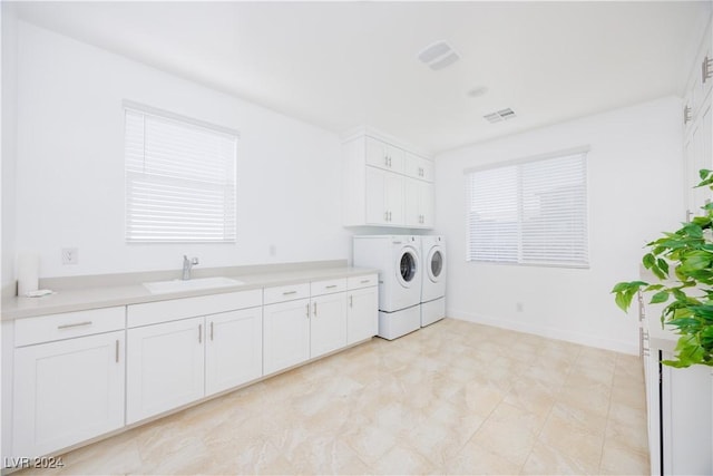 510 Duvet Ct, Henderson, NV 89012 - washroom featuring a sink, washer and clothes dryer, visible vents, baseboards, and cabinet space