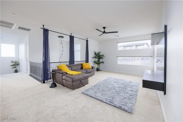 carpeted living room with ceiling fan