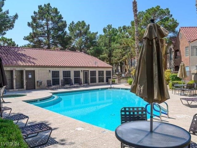 view of swimming pool featuring a patio area