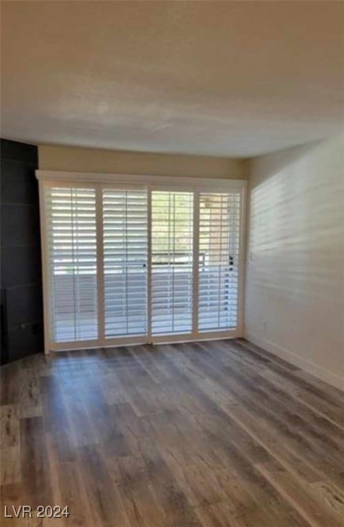 unfurnished room featuring dark hardwood / wood-style floors and a wealth of natural light