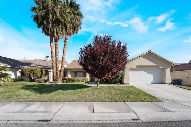 view of front of property with a garage and a front lawn