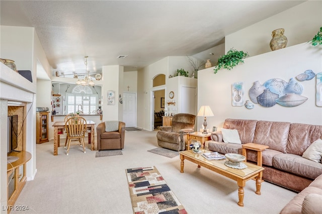 living room with light colored carpet, a notable chandelier, and lofted ceiling