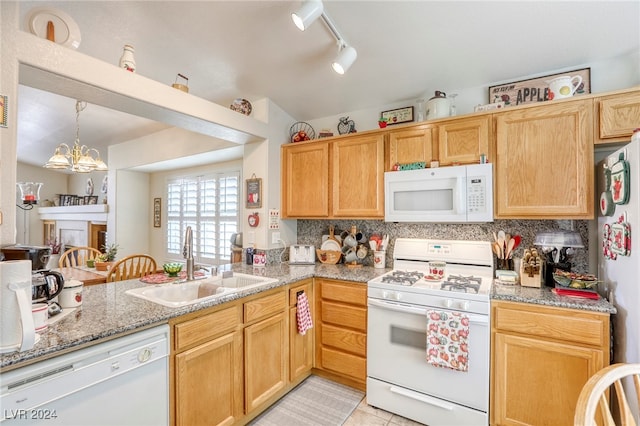 kitchen featuring decorative backsplash, white appliances, kitchen peninsula, sink, and a notable chandelier