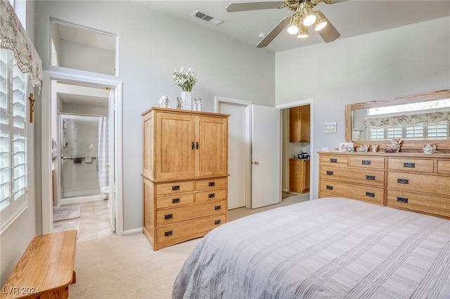 carpeted bedroom featuring ceiling fan and ensuite bath