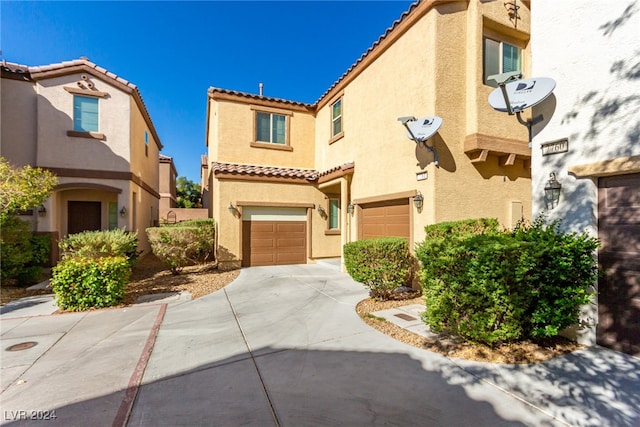 mediterranean / spanish-style home with a garage