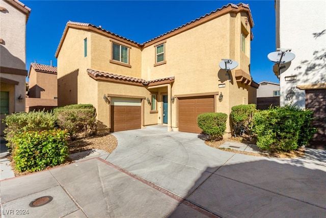 mediterranean / spanish-style home with a garage