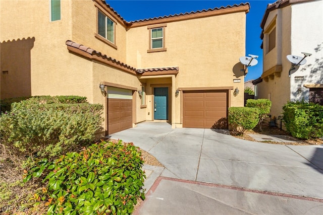 mediterranean / spanish house featuring a garage