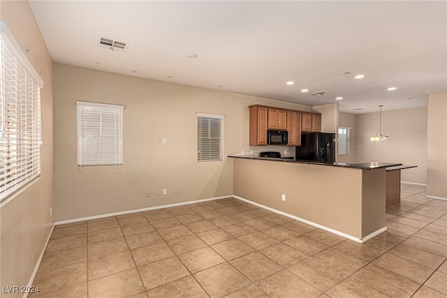 kitchen with kitchen peninsula, light tile patterned floors, hanging light fixtures, and black appliances