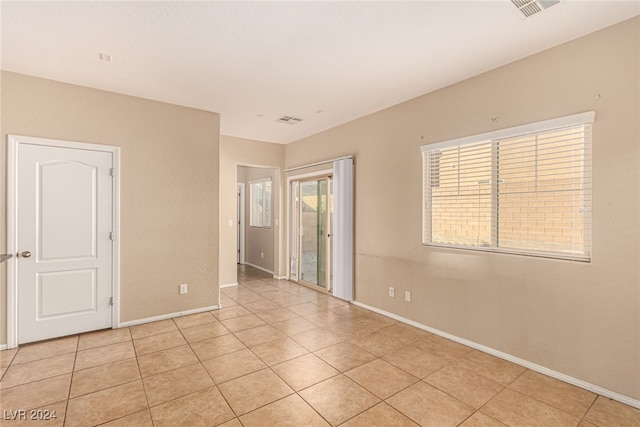 spare room featuring light tile patterned floors