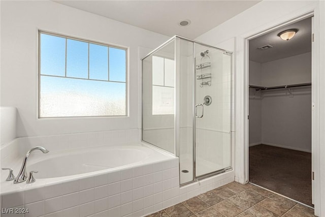 bathroom featuring tile patterned floors and plus walk in shower