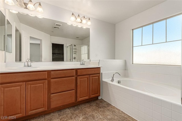 bathroom with tile patterned floors, vanity, and independent shower and bath