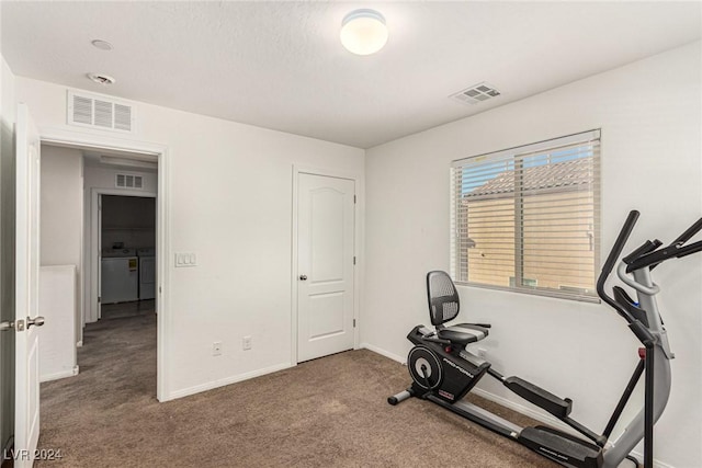 exercise area with carpet and washer and dryer