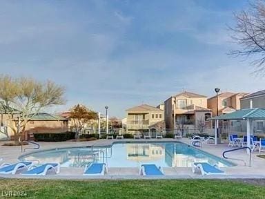 view of pool featuring a yard and a patio