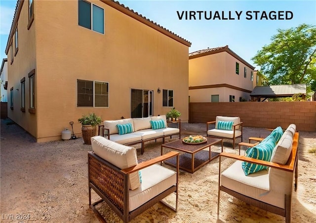 rear view of house featuring a patio area and an outdoor living space