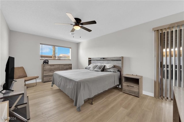 bedroom with ceiling fan and light hardwood / wood-style flooring