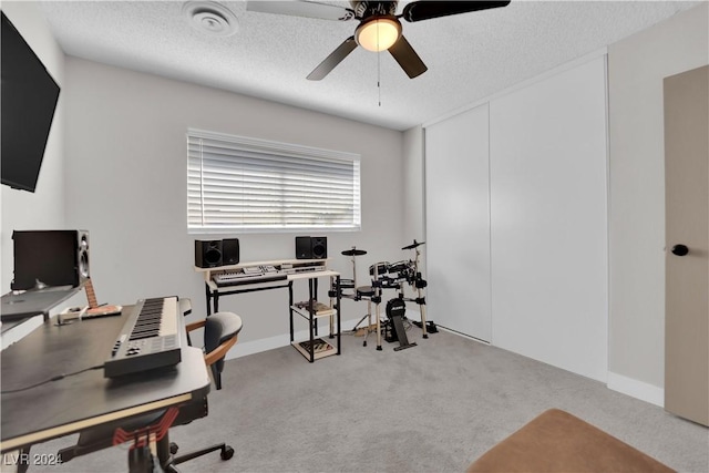 office featuring light carpet, a textured ceiling, and ceiling fan