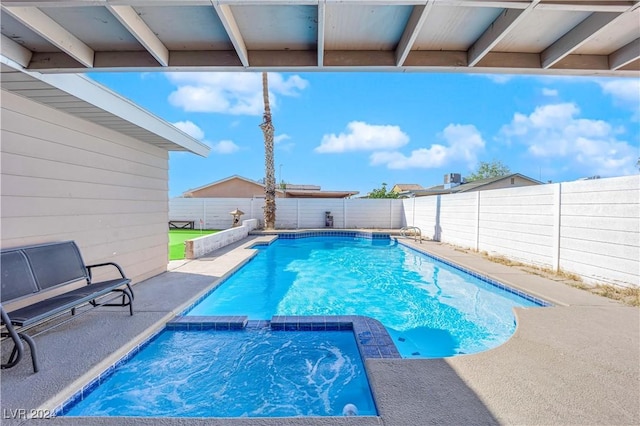 view of swimming pool with an in ground hot tub