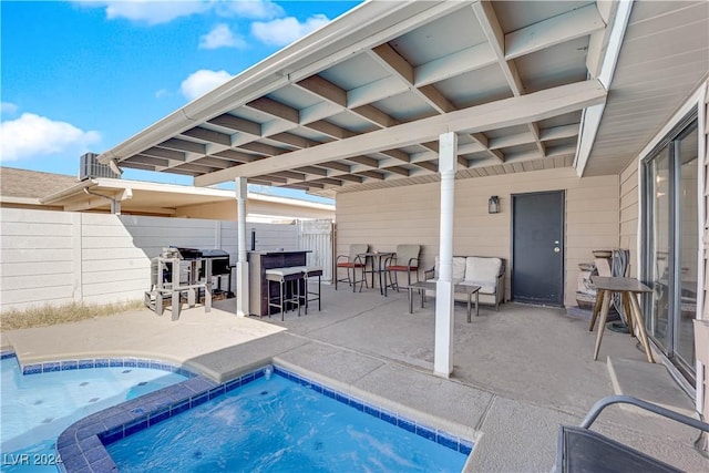 view of pool with a bar and a patio area