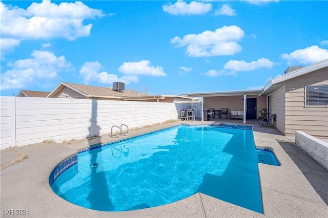 view of swimming pool with a patio and central air condition unit